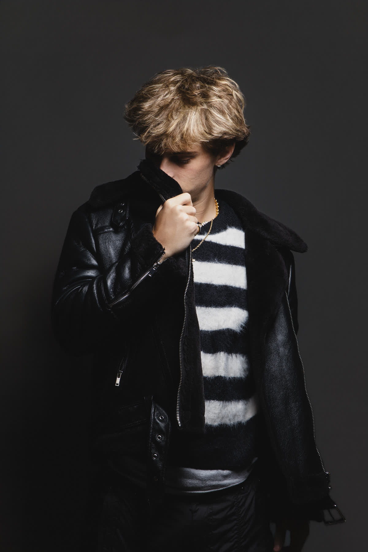 Oliver Fox in a black leather jacket against a dark backdrop